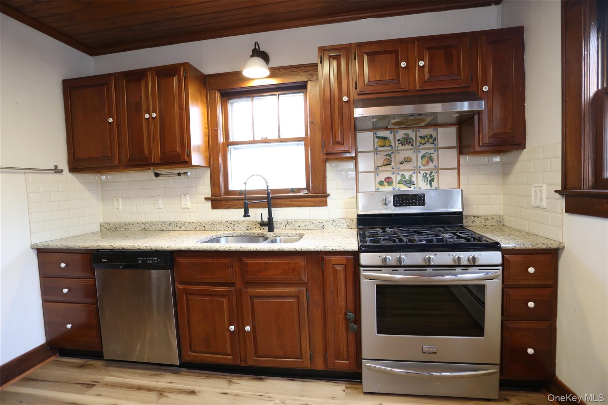 113 Brewery Road New City, NY 10956 - Photo 4 of 39 Kitchen featuring stainless steel appliances, backsplash, under cabinet range hood, light stone countertops, and wooden ceiling