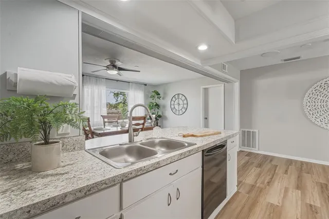 a view of a dining room with furniture and a potted plant