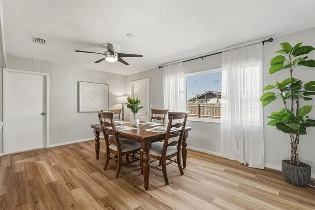 a view of a dining room with furniture window and wooden floor