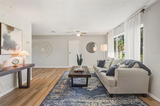 a living room with furniture and a mirror