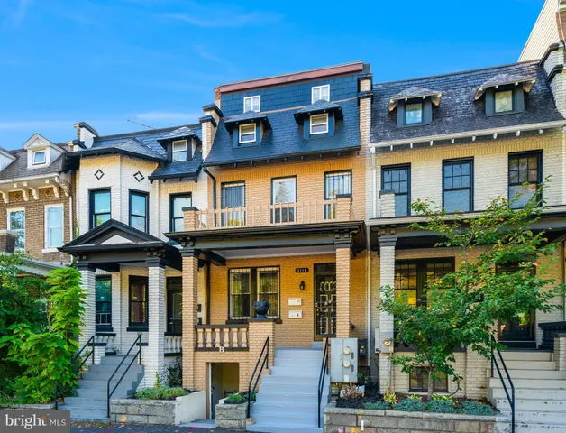 a front view of a residential apartment building with a yard