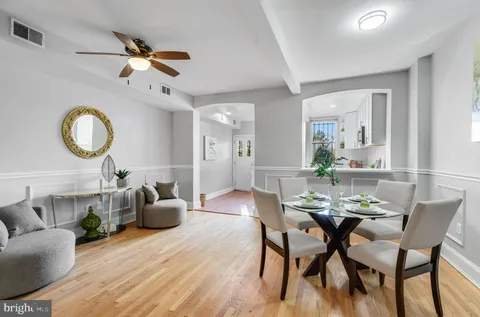 a view of a dining room with furniture and wooden floor