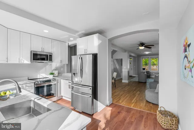 a kitchen with stainless steel appliances a sink a stove and a refrigerator