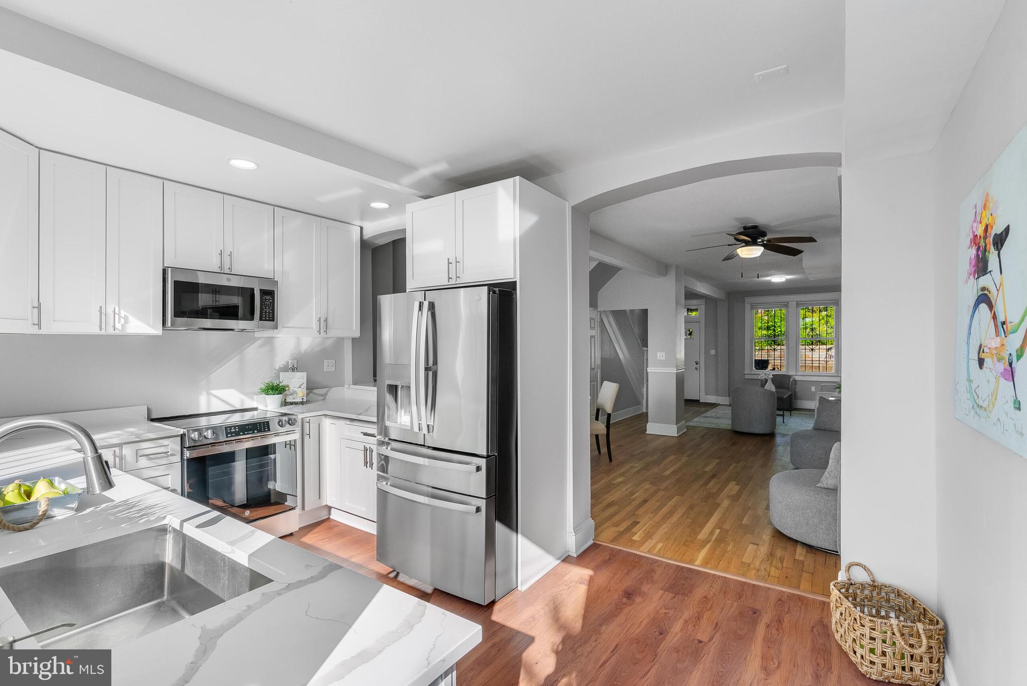 2116 North Capitol Street Northwest Washington, DC 20002 - Photo 19 of 50 a kitchen with granite countertop a refrigerator and a stove top oven