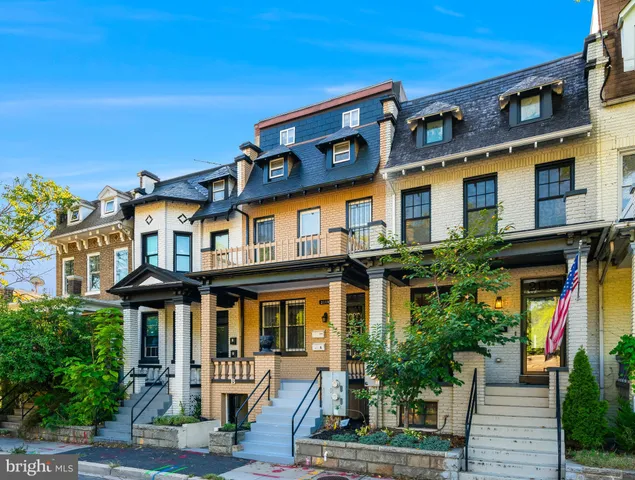 a front view of a residential apartment building with a yard