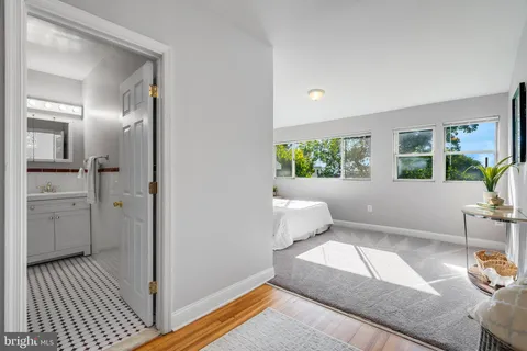 a spacious bedroom with a bed and a chandelier