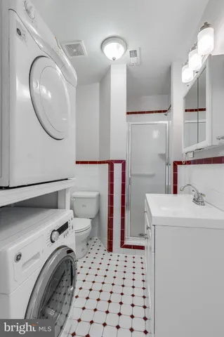 a white toilet sitting next to a bathroom sink