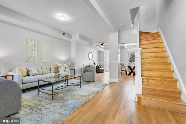 a living room with furniture and wooden floor