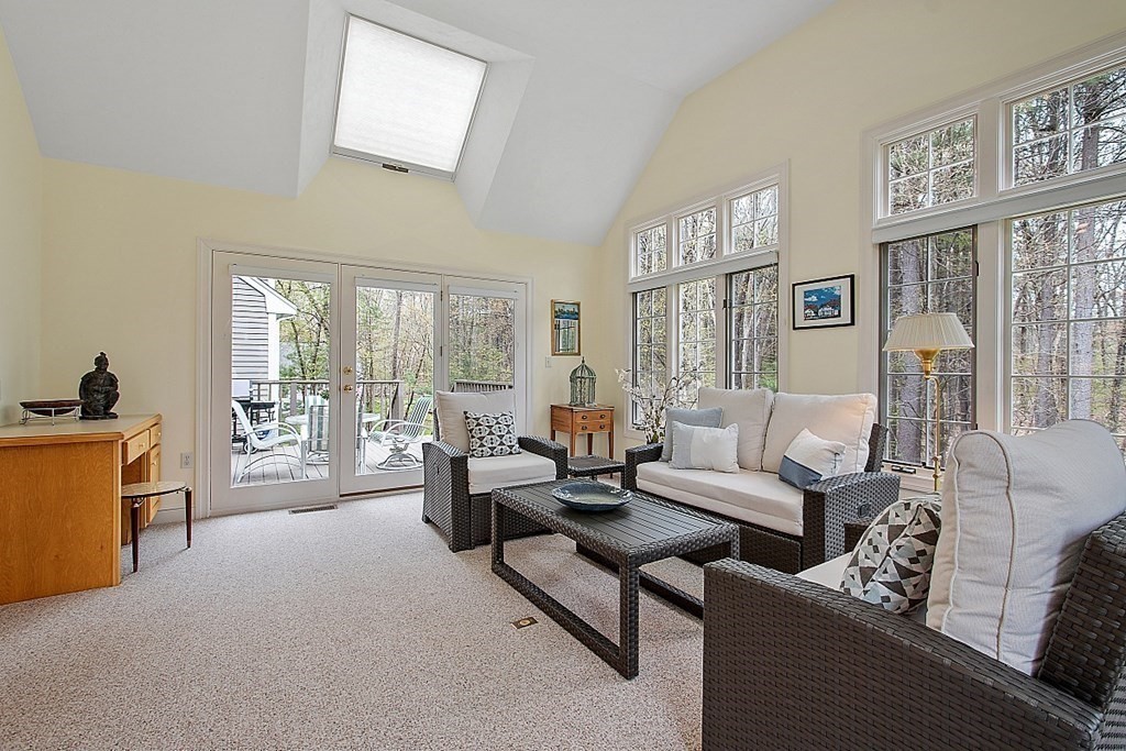 195 Lancaster Road North Andover, MA 01845 - Photo 14 of 42 a living room with furniture a large window and a flat screen tv