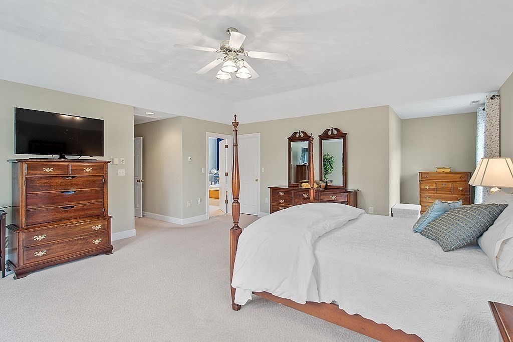 195 Lancaster Road North Andover, MA 01845 - Photo 19 of 42 a bedroom with a bed and a flat screen tv