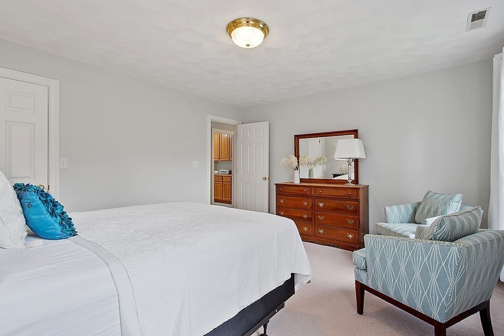 195 Lancaster Road North Andover, MA 01845 - Photo 23 of 42 a bedroom with a bed and a dresser in it