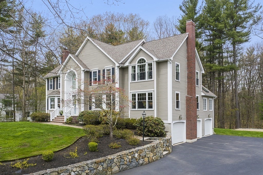 195 Lancaster Road North Andover, MA 01845 - Photo 34 of 42 a view of a white house next to a yard with big trees