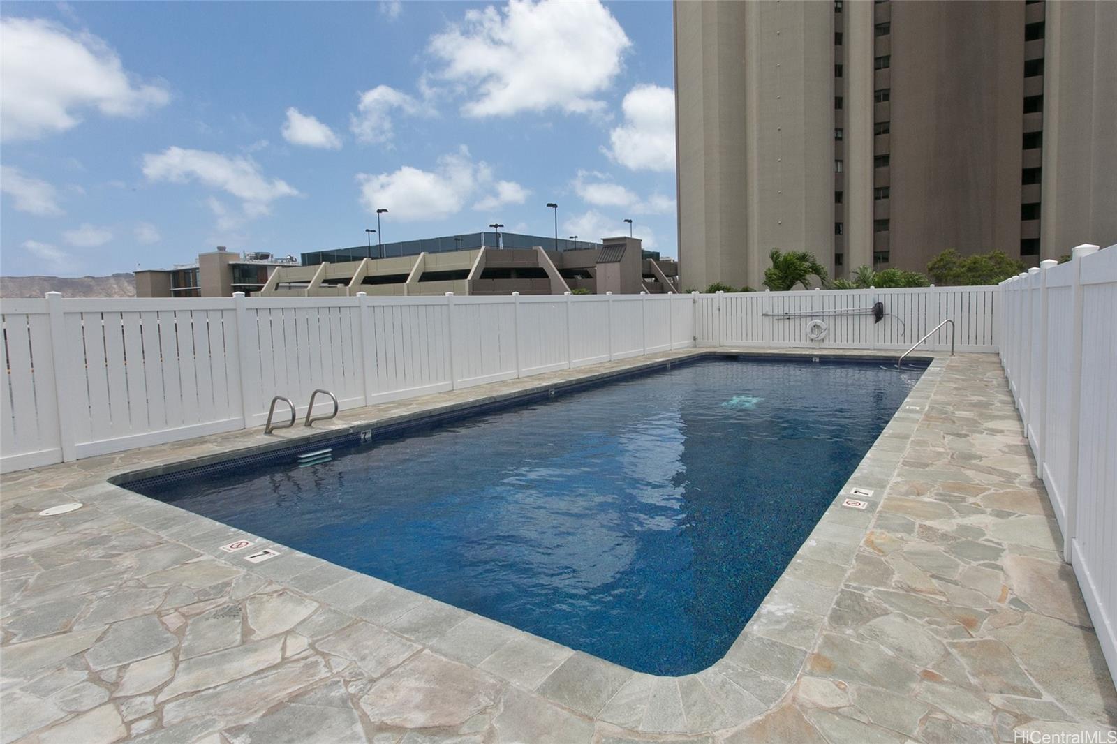 2525 Date Street, Unit 1705 Honolulu, HI 96826 - Photo 11 of 11 a view of a swimming pool with a yard