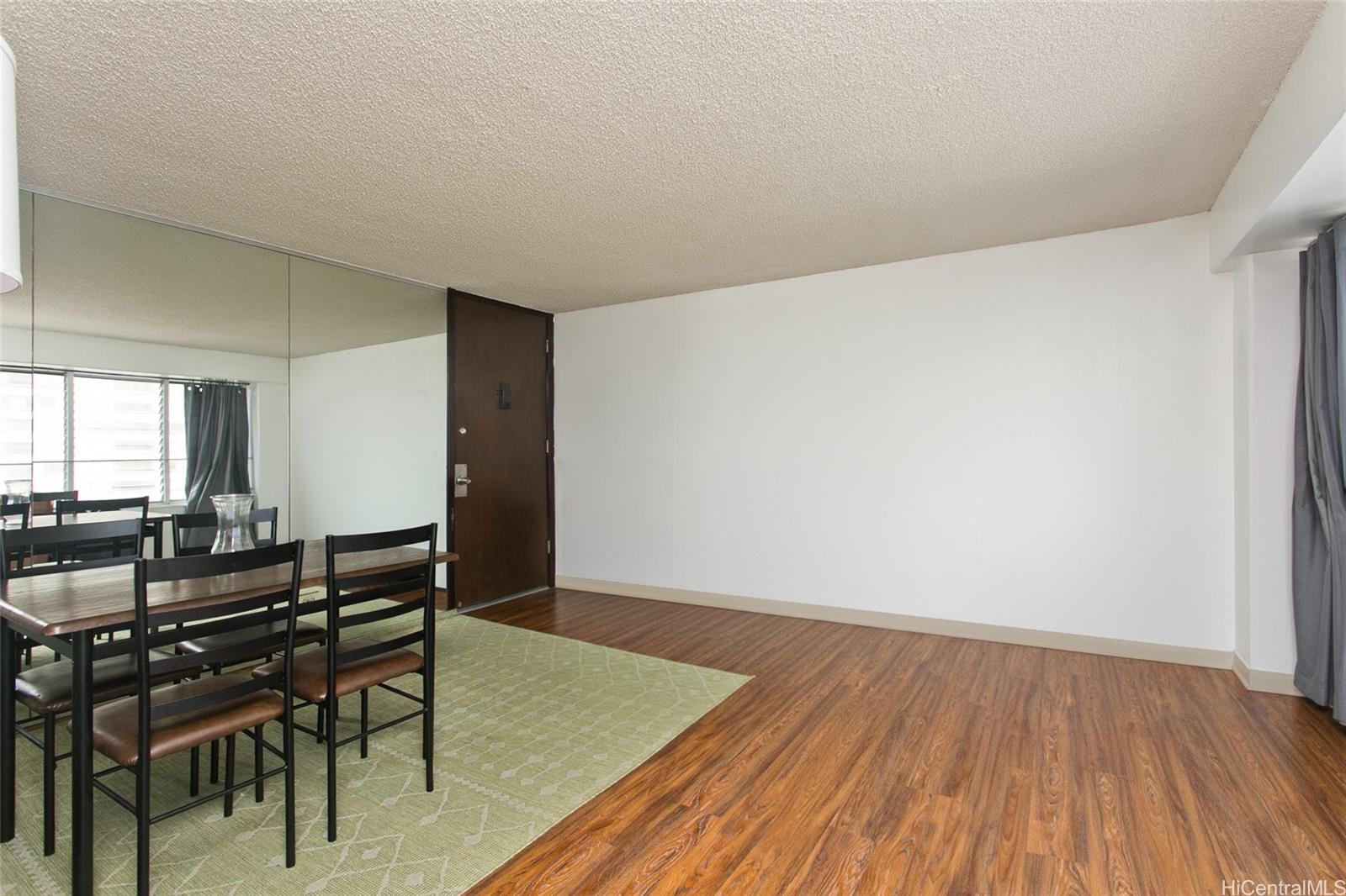 2525 Date Street, Unit 1705 Honolulu, HI 96826 - Photo 2 of 11 a room with wooden floor and furniture
