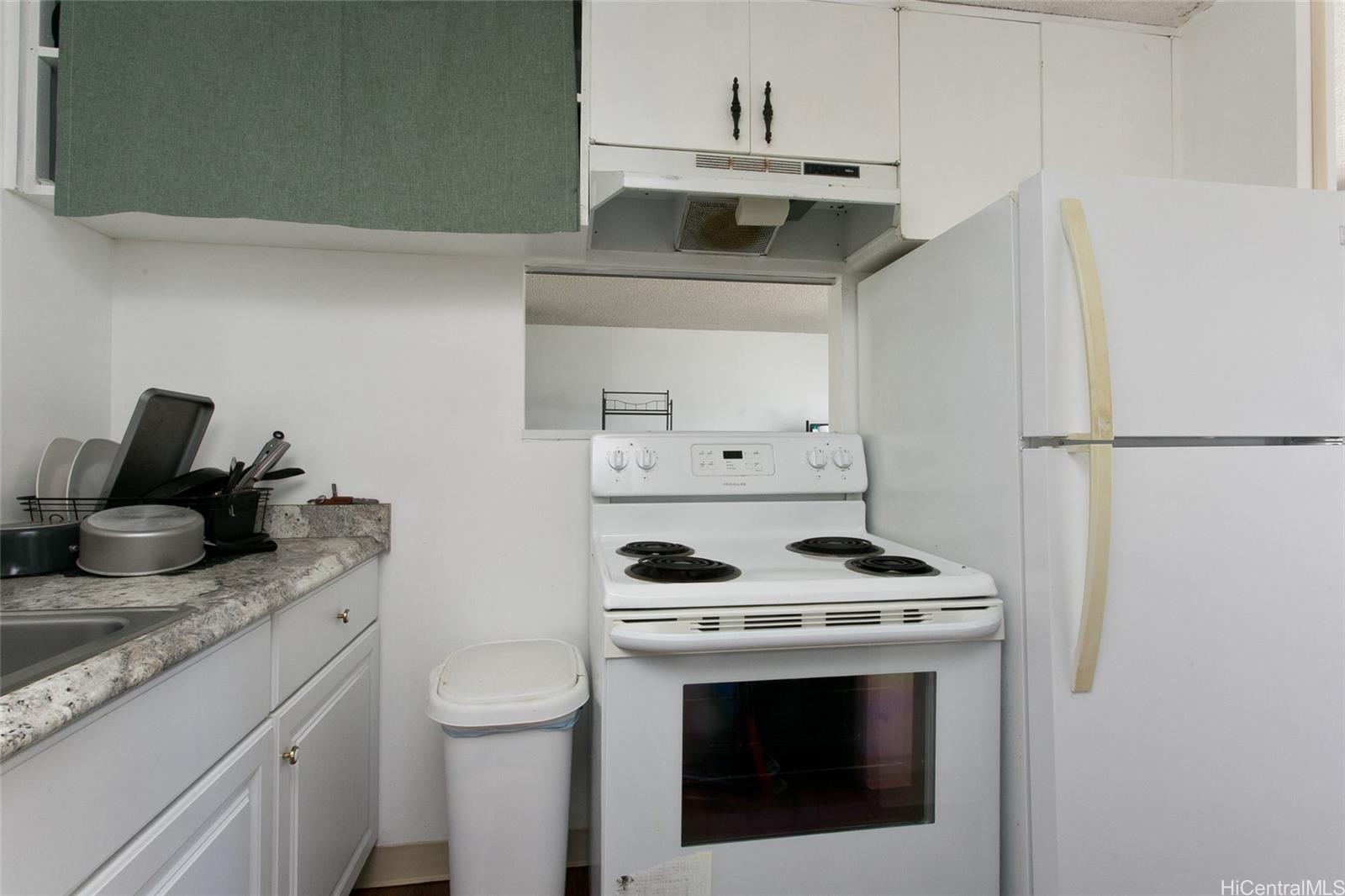 2525 Date Street, Unit 1705 Honolulu, HI 96826 - Photo 6 of 11 a kitchen with stainless steel appliances granite countertop a sink stove and refrigerator