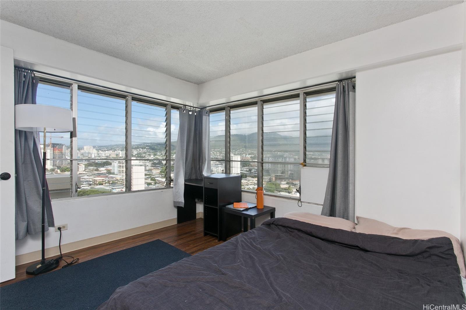 2525 Date Street, Unit 1705 Honolulu, HI 96826 - Photo 8 of 11 a living room with furniture and a large window
