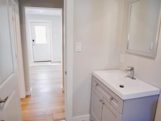 a bathroom with a sink mirror and vanity