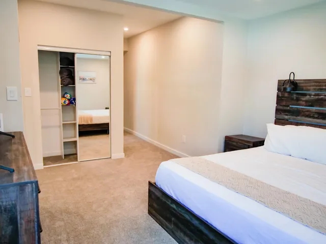 a bedroom with a bed and cabinets