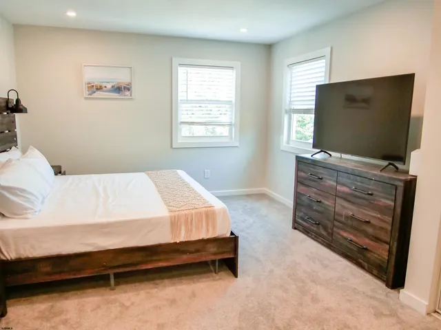 a bedroom with a bed and flat screen tv