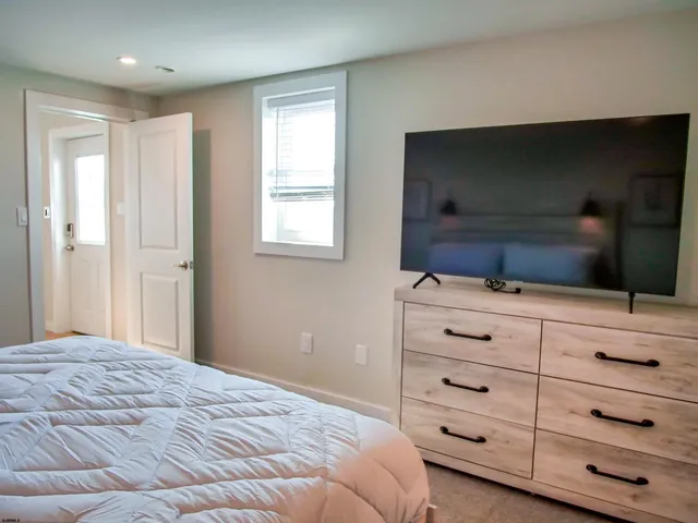 a bedroom with a bed and a television