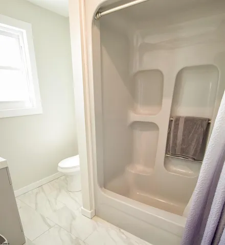 a bathroom with a toilet and a bathtub