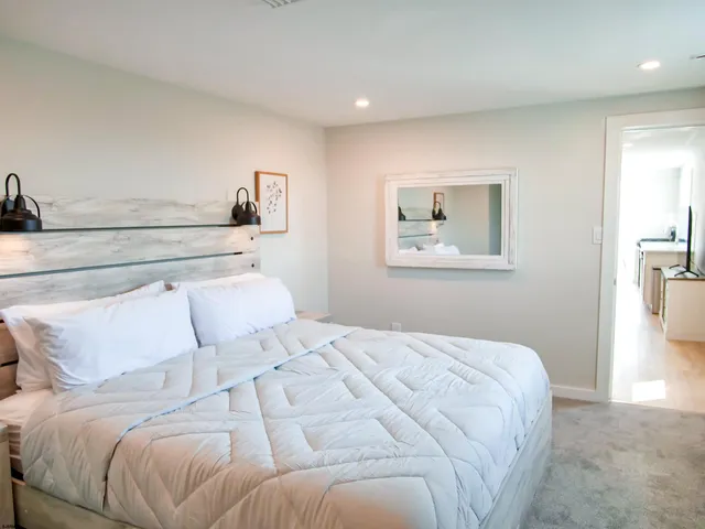 a bedroom with a bed and a painting on the wall