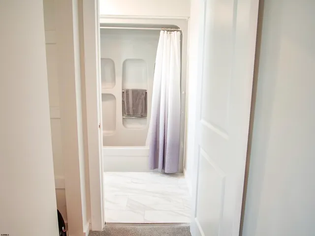 a view of a bathroom from a hallway