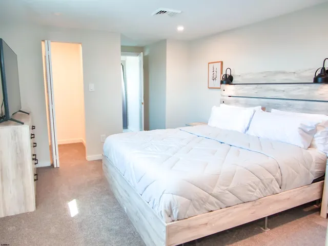 a large white bed in a white room