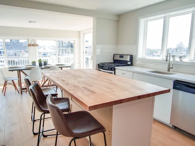 a kitchen with a stove a sink and a refrigerator