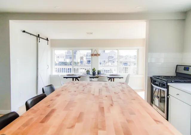 a large white room with a bed and a large window