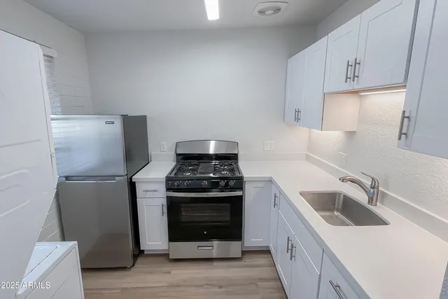 a kitchen with a stove sink and refrigerator