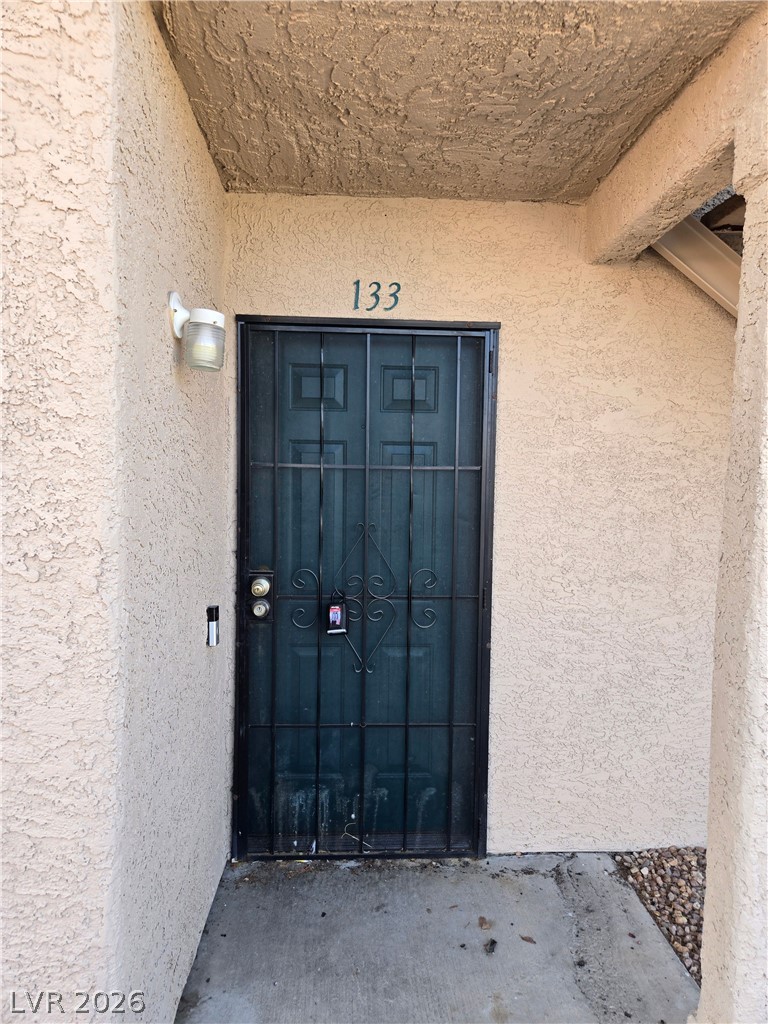 6750 Del Rey Avenue, Unit 133 Las Vegas, NV 89146 - Photo 2 of 34 Secure entry to a residence, featuring robust ironwork on the main door.