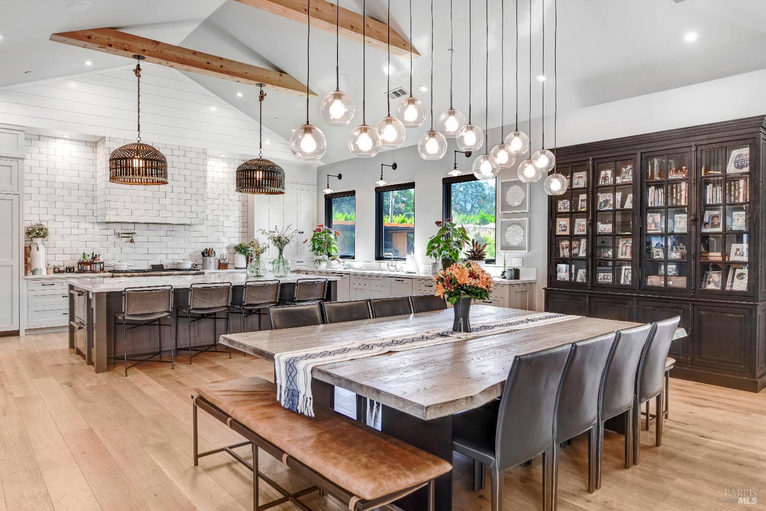85 Trinity Road Glen Ellen, CA 95442 - Photo 15 of 62 a dining room with wooden floor a chandelier a wooden table and chairs