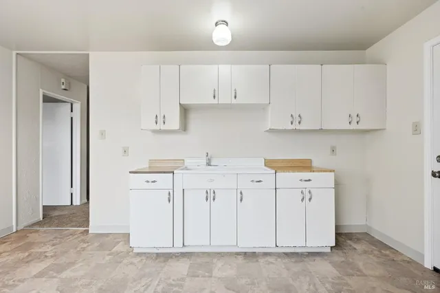 a view of cabinets with white cabinets