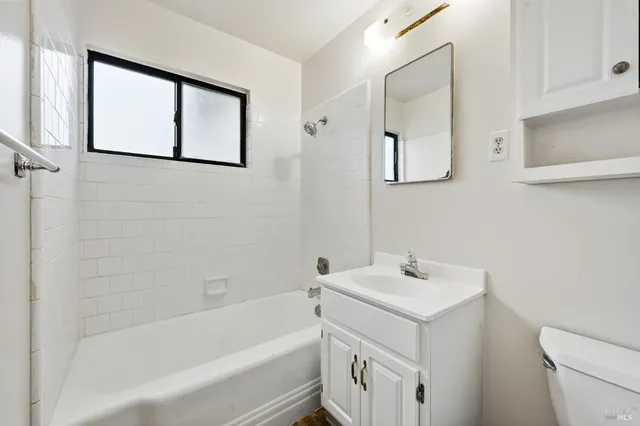 a bathroom with a sink a mirror and a bathtub