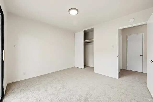 an empty room with closet and area