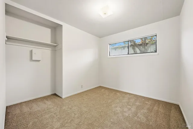 a view of an empty room with closet
