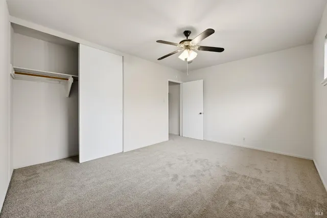 a view of an empty room with a fan