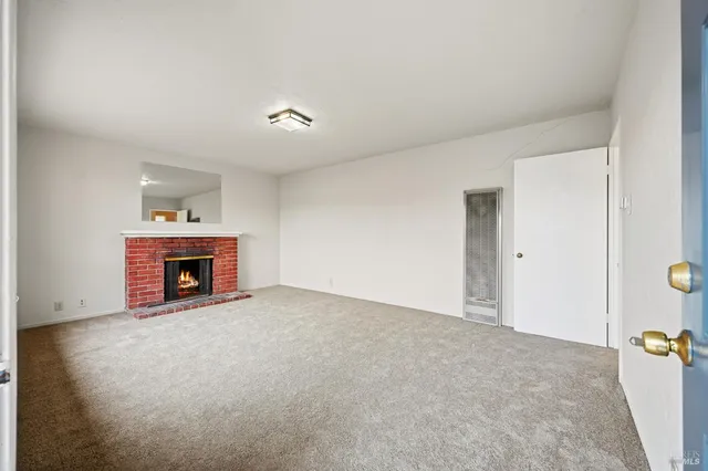 a view of an empty room with a fireplace