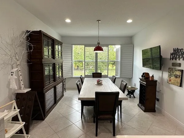 a view of a dining room with furniture window and outside view