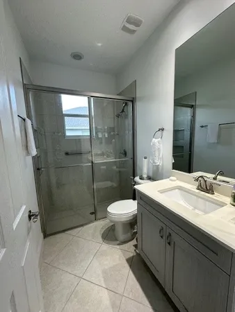 a bathroom with a glass shower door