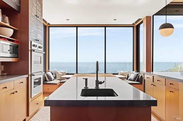 a kitchen with a large window and a sink