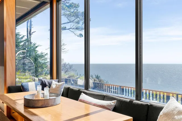 a view of a city from a dining room with a table and chairs