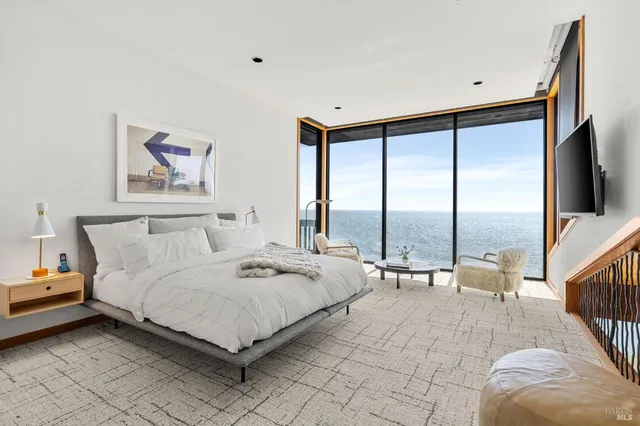 a spacious bedroom with a bed and a large window