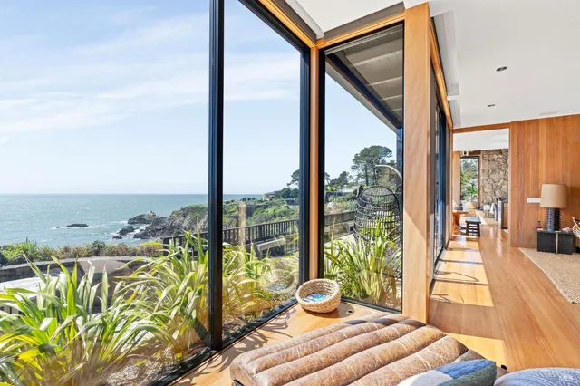 a view of a living room and floor to ceiling window or wooden floor
