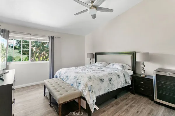 a bedroom with a bed and wooden floor