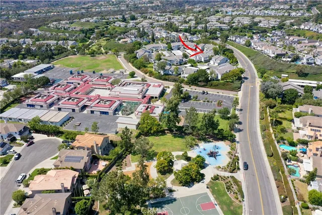 an aerial view of residential houses with outdoor space and swimming pool