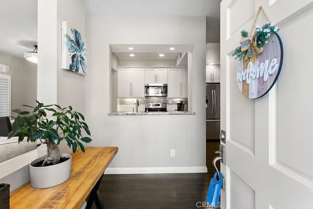 a dining room with furniture and a potted plant