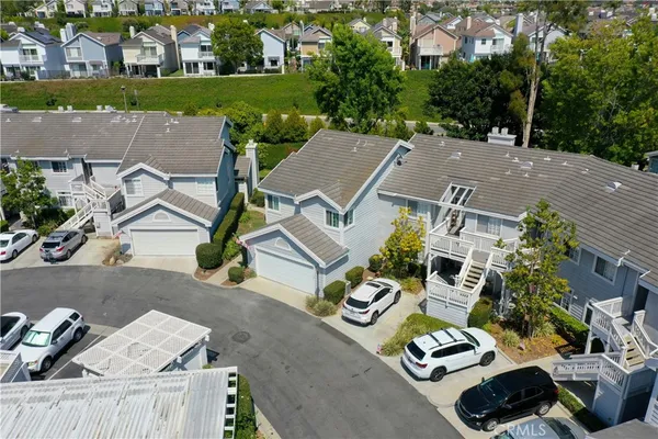 an aerial view of a house with garden space and street view
