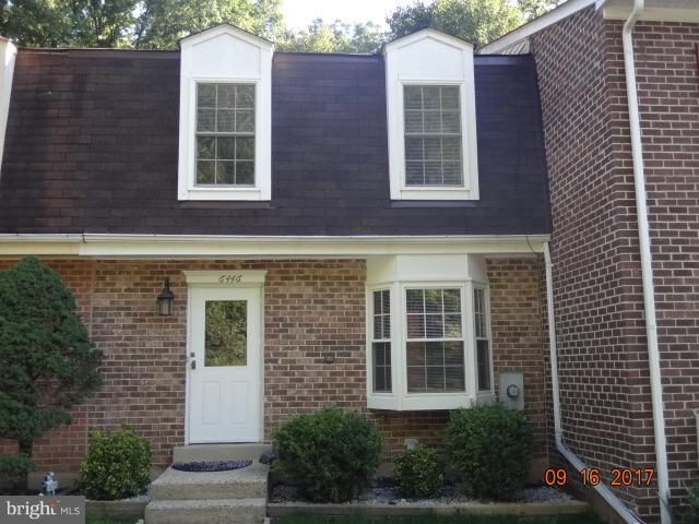 a view of a brick building next to a yard